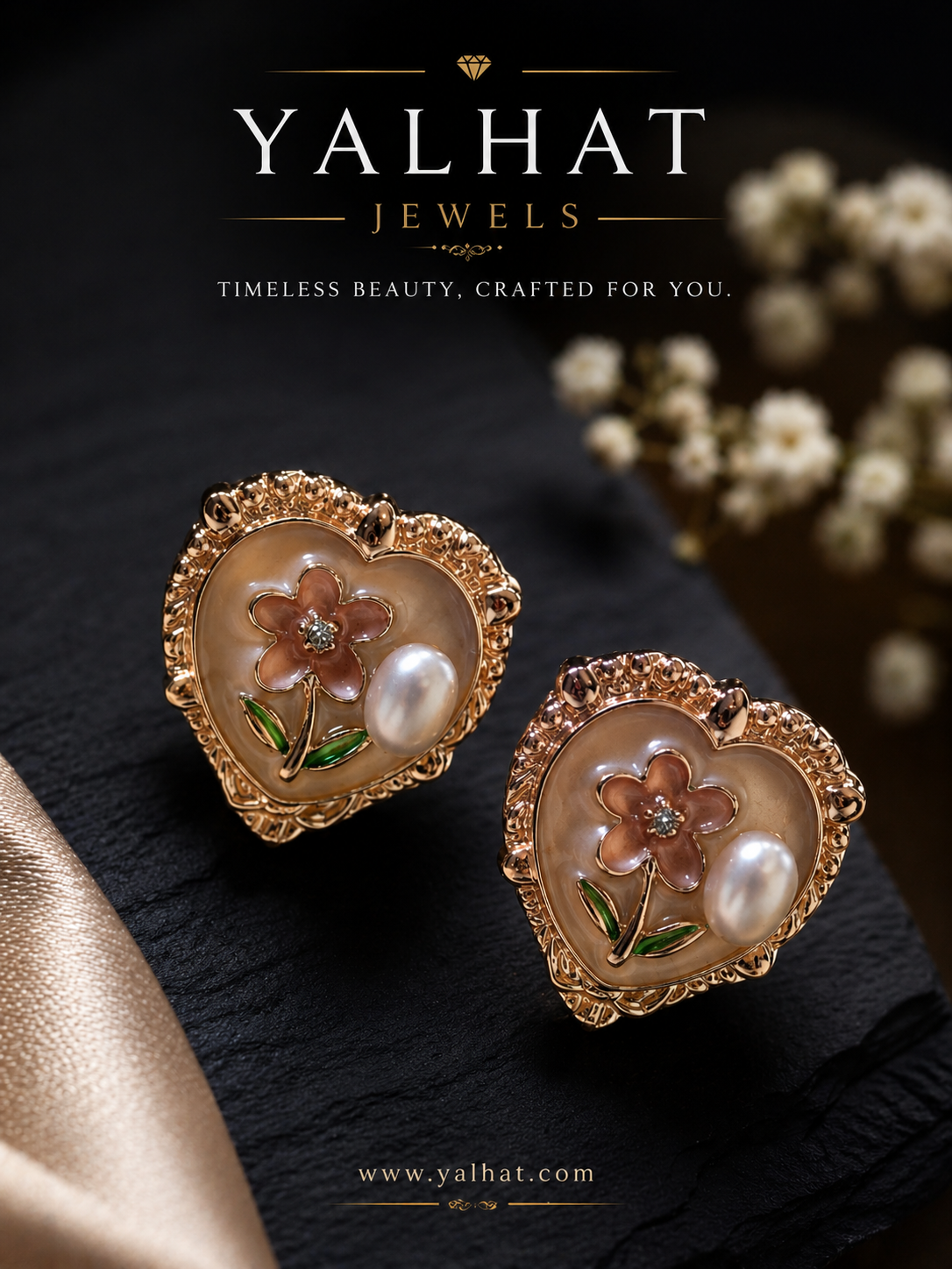 Heart-shaped earrings with floral design and pearl accents on a dark surface, branded as Yalhat Jewels.
